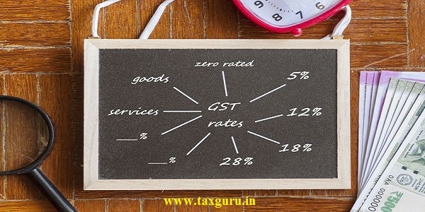 GST - Goods and Services Tax - Conceptual top view image of India GST role-out. Magnifying glass on notepad, red clock on Indian currency notes, computer mouse on wooden surface.  