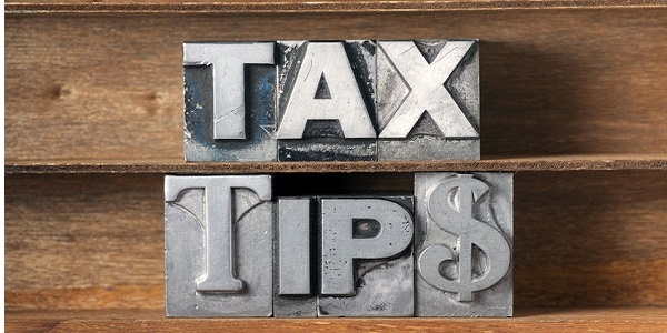 tax tips phrase made from metallic letterpress type on wooden tray