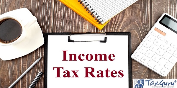 Income Tax Rates text on paper with coffee, calculator and notebook