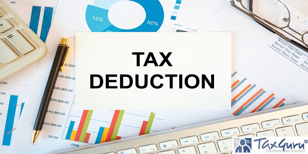 TAX DEDUCTION is written in a document on the office desk with office accessories