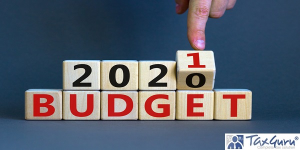 Male hand flips wooden cube and change the inscription 'BUDGET 2020' 