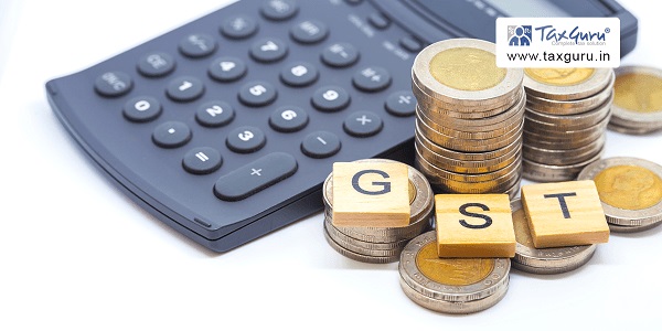 GST on wooden Cube with calculator and coins