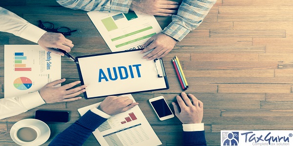 Auditing concepts - Auditor at table during examination of financial report