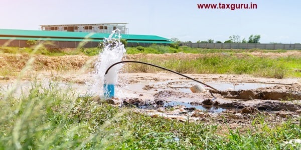 The water flowing artesian well after hole drilling machine installed for the water supply