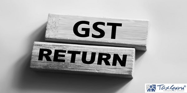 GST return text on wooden blocks on grey background