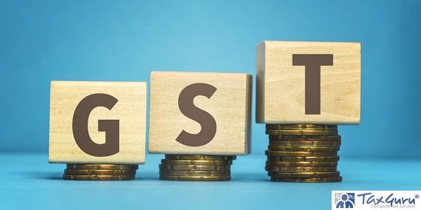 gst (Goods and Services Tax) concept with wooden blocks and coins on table