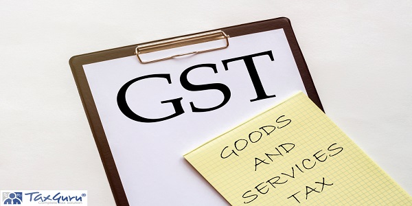 white and yellow paper with text GST GOODS AND SERVICES TAX on a white background with stationery