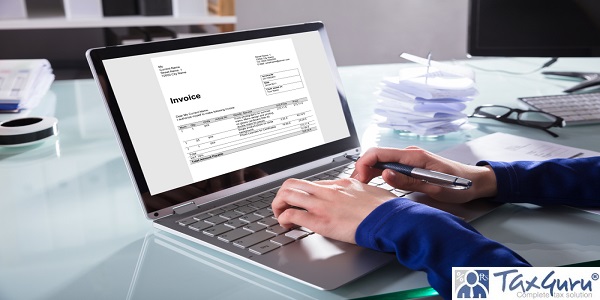 Close-up Of A Businessperson's Hand Analyzing Invoice On Laptop At Workplace