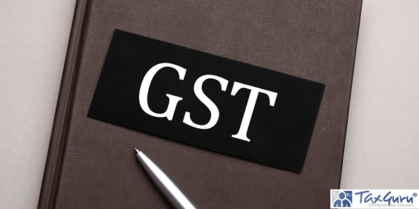 GST GOODS AND SERVICES TAX sign written on the black sticker on the brown notepad