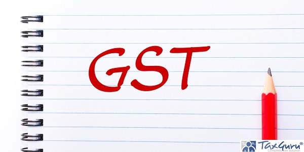GST Goods and services tax written on notebook page with red pencil on the right