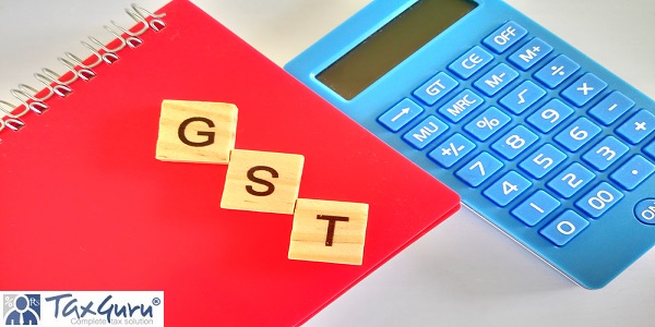 Good and Service Tax (GST) wooden cube on red book