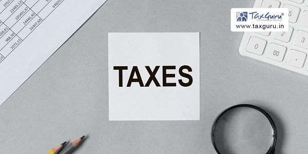 Taxes is written in a white stick note