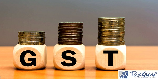 Wood cube block letters GST and money coin stack on table wooden gray background