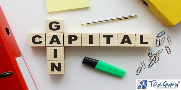 Wooden cubes with words GAIN CAPITAL on the office desk