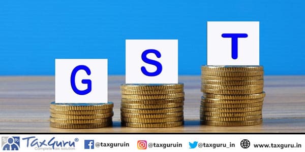 Close-up of gst letter blocks on stacked coins