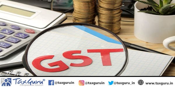 GST word in notebook under magnifying glass and calculator